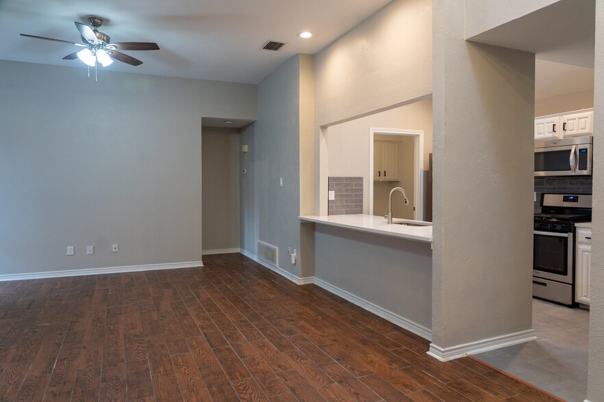 Open concept Kitchen, dining and living room. Features wood look tile throughout the home. scrapped ceilings, fresh interior paint, gas logs in the fire place and all new ceiling fans and light fixtures throughout. - 812 Via Madonna