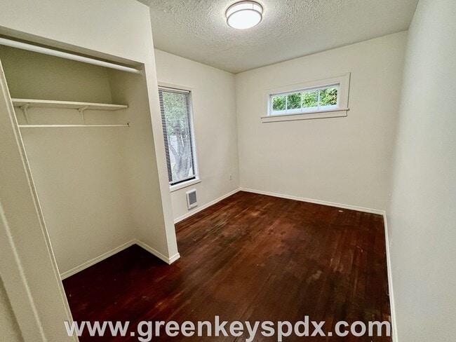 Building Photo - This 3-bedroom 1-bathroom house has a large front yard and a mostly fenced backyard.