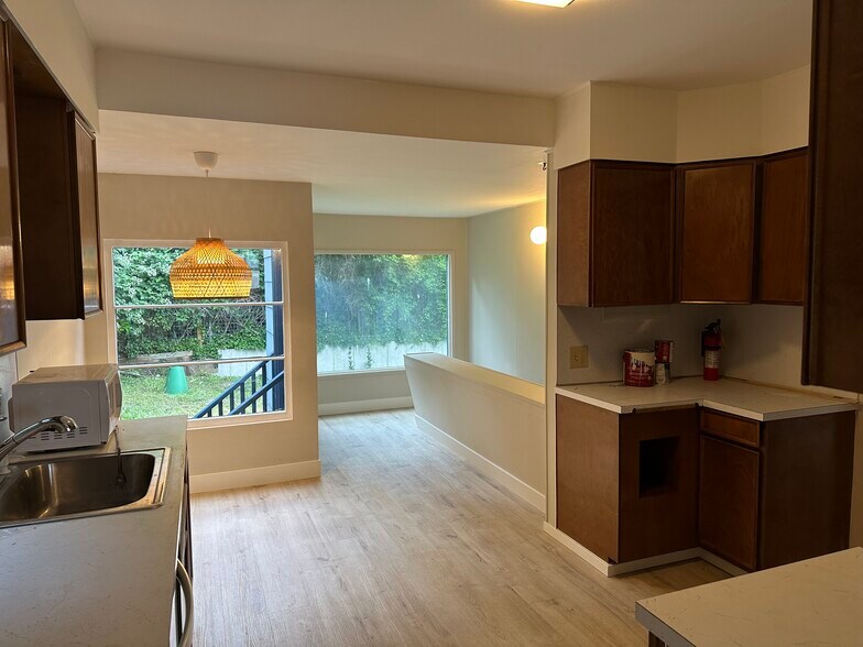 Kitchen/Dining with back door to backyard, stairs to basement - 4038 Greenwood Avenue North