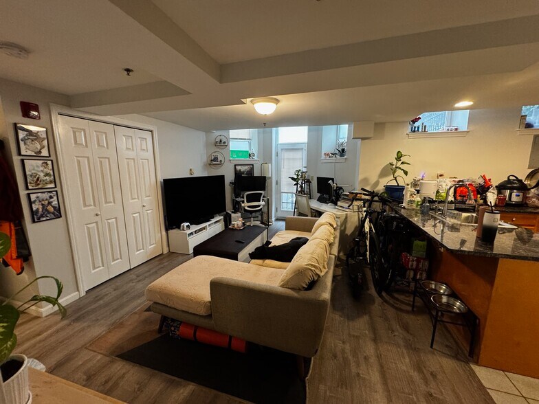 Living room, in-unit laundry behind closet doors - 36 Peterborough St