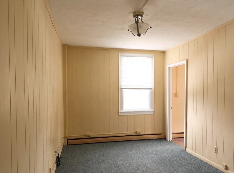 Living room looking towards large bedroom - 100 N Main St