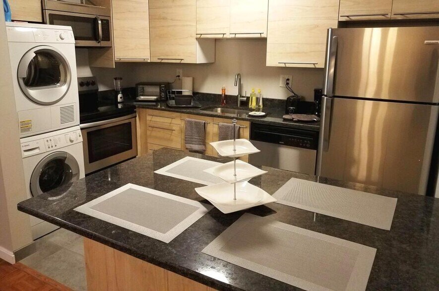 This modern kitchen has everything, even a washer/dryer. - 516 S 12th St