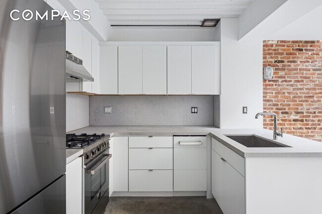 Building Photo - Loft-style one-bedroom with double-height ceilings, oversized windows, and private garden in the ...