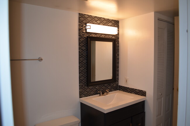 Bath with new vanity and tile surround - 7401 Westlake Ter