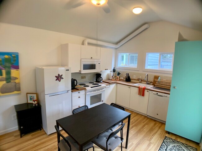 Here's the kitchens with dishwasher and a washer dryer behind the blue door - 3405 NE 80th Ave