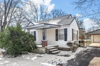 Building Photo - Charming White Cottage with Black Metal Ro...