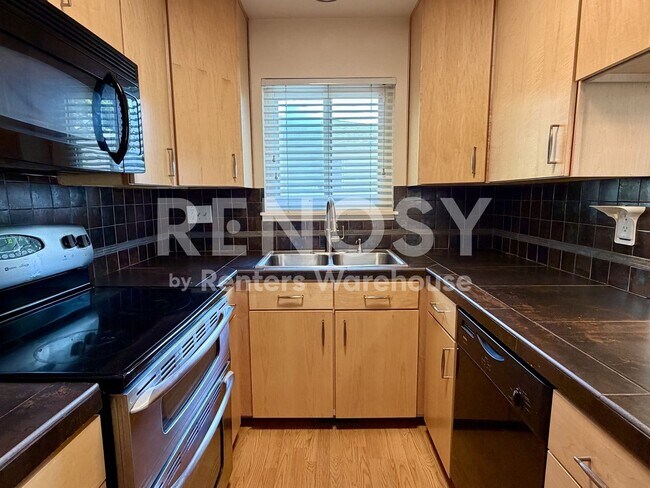 Building Photo - Extremely Well Located and Updated 2 Bed/ 1 Bath Condo with direct Garage Access