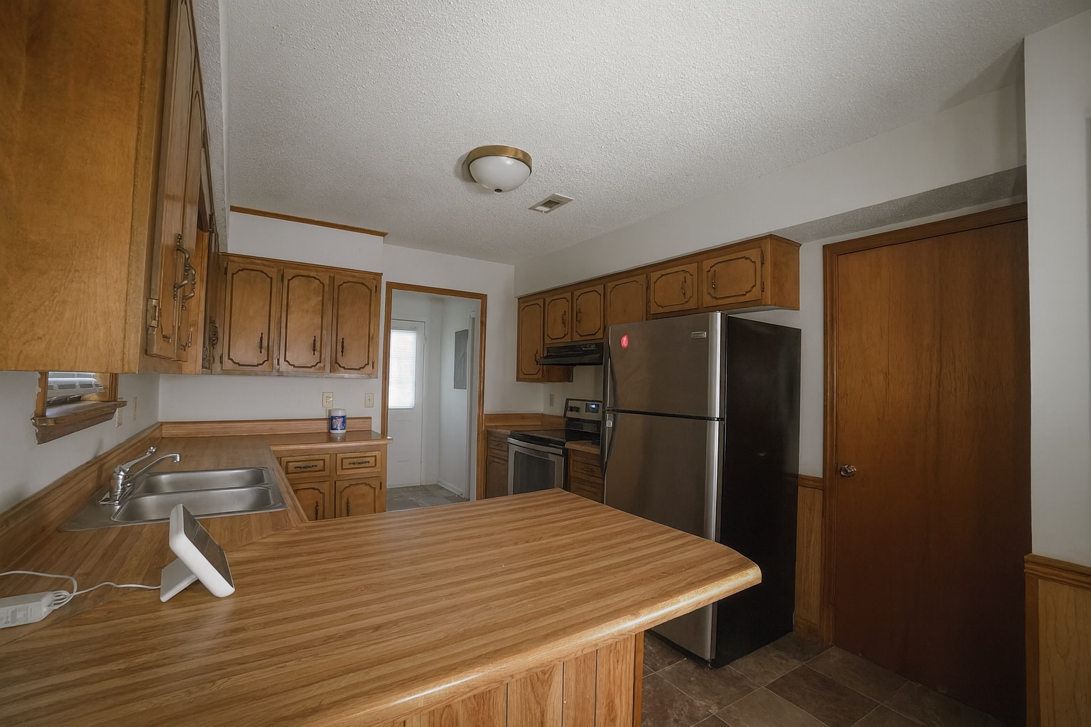 Spacious kitchen with ample storage, breakfast bar, and double sink for easy entertaining. - 2313 Salem West Dr