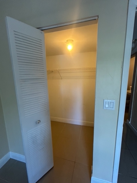 view of walk in closet - 490 NW 20th St