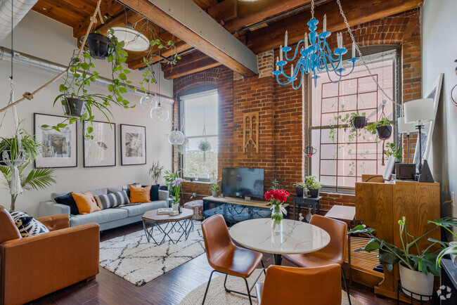 Living Room with Exposed Brick and Beams - Aria Cultural District Lofts