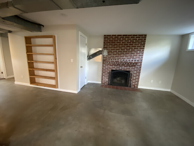 Basement - shelving and fireplace - 3200 SE 78TH AVE