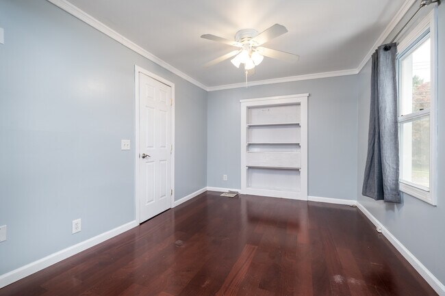 Primary bedroom with crown molding and built ins - 1099 North Ave