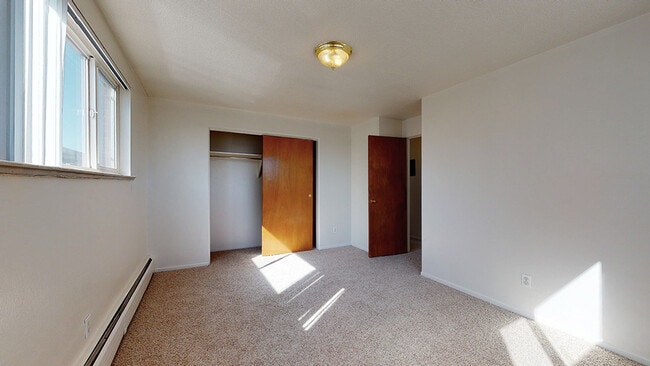 Embrace natural light in this airy bedroom, perfect for restful nights. - Flats at Sloan's Lake West