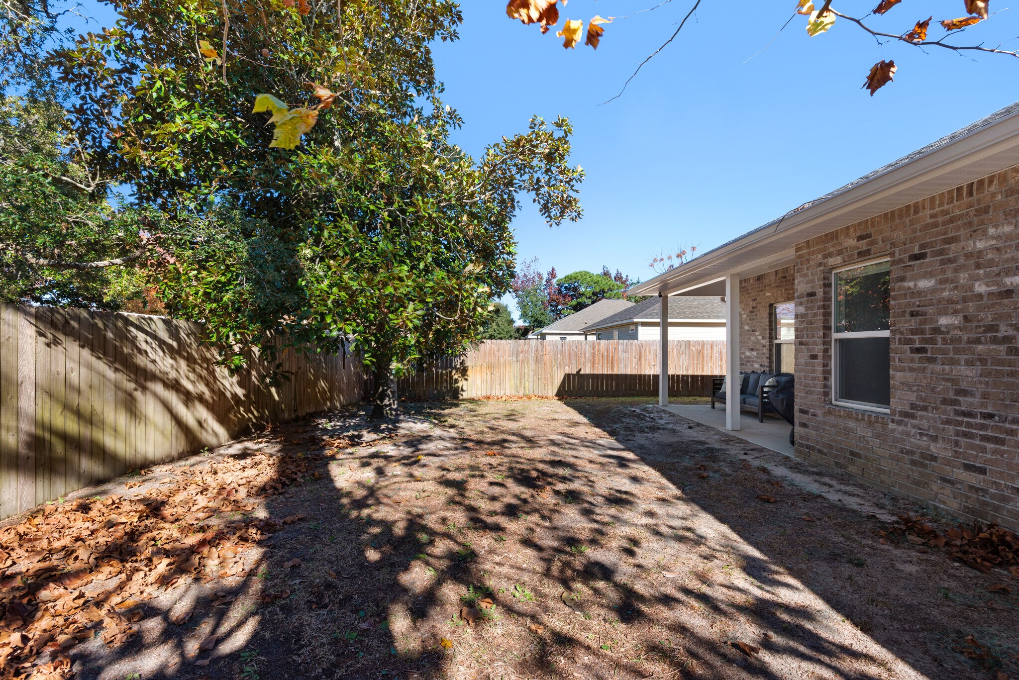 Backyard has a private fence, patio furniture, and barbecue - 28 Snook Rd