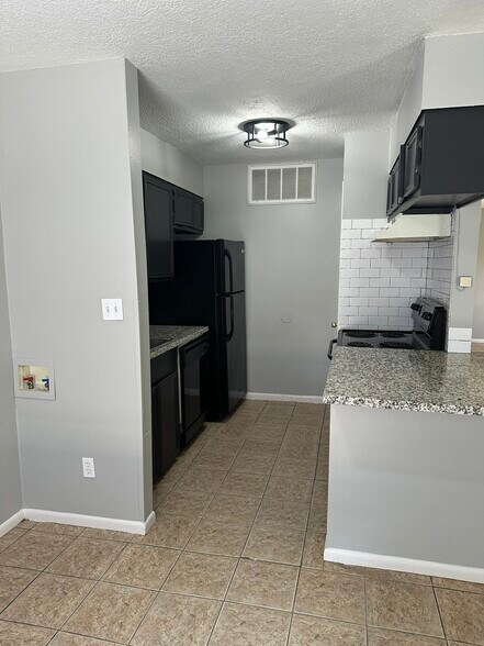 Granite counter tops, subway tile, refrigerator, stove/oven, dishwasher, closet style pantry - 705 Edgar St