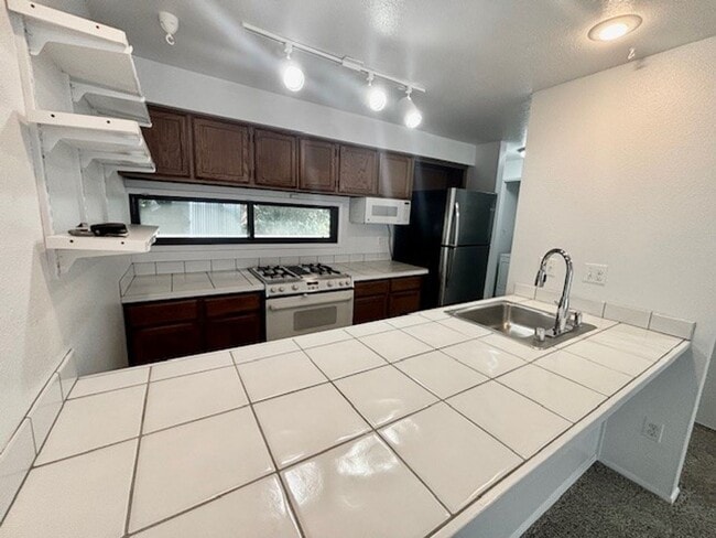 Building Photo - DES MOINES CONDO WITH PEEK-A-BOO SOUND VIEWS & PRIVATE GARAGE!