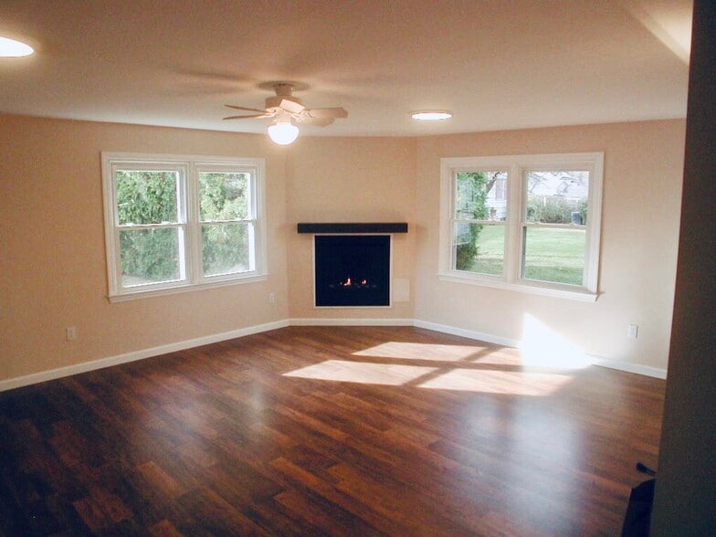 Living room looks out to park-like setting. Propane fireplace - 23 Fairlawn Ave