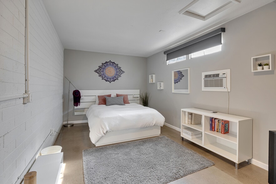 Fourth bedroom set up as guest room with private AC unit, blackout shade and modern touches - 6136 N 9th St