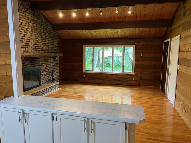 Large living area with brick fireplace (not currently operational) - 1120 Lealand Rd E