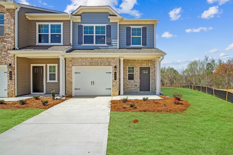Exterior of the Aberdeen Layout, two story townhome with a private driveway and attached garage. - Satterfield Commons