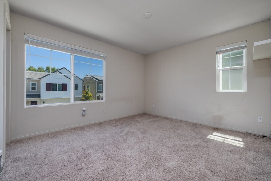 Another view of the first upstairs bedroom featuring windows facing east and south - 26549 Brightstone Dr