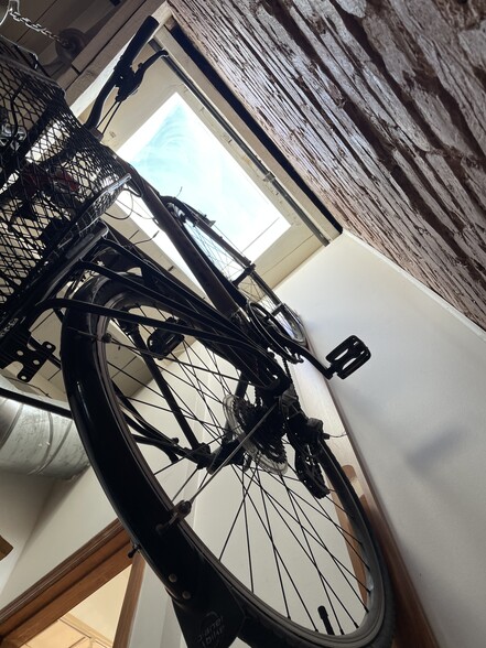Every room has either a skylight or a window. Here is the entry hallway with a skylight and a hanging bike above. - 1003 P St NW