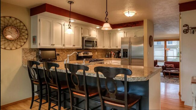 Building Photo - 4bd/3ba HUGE Home w/Hardwood Floors, Russian Fireplace, 2-Car Garage & Fenced Back Yard!