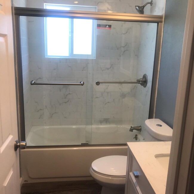 Bathroom walls freshly painted with new flooring and fixutures. Nickel finished glass shoor doors recently installed. Everything is new. - 1450 166th Ave