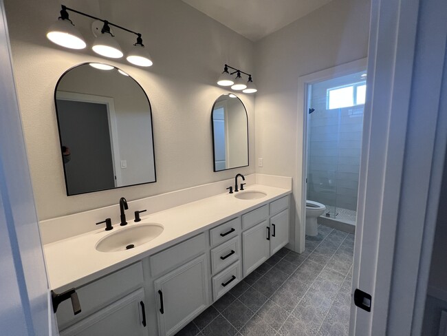 Guest bathroom updated with new tiles and glass shower door - 34189 Hourglass St