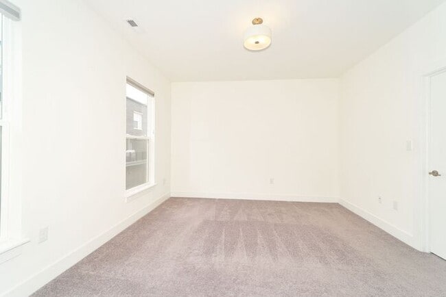 Building Photo - Like New Townhome With Your Own Rooftop Views of Downtown Indy!