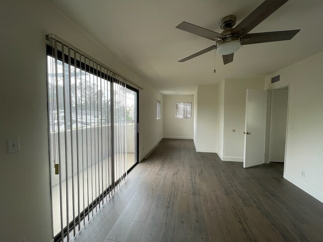 main bedroom opposite view with ceiling fan/light and sitting area or office - 10330 Riverside Dr