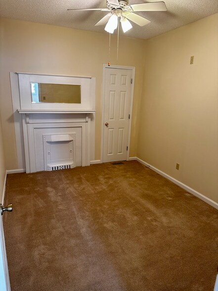 Secondary Bedroom (Fireplace is for aesthetics only and does not work). - 502 E Tombigbee St