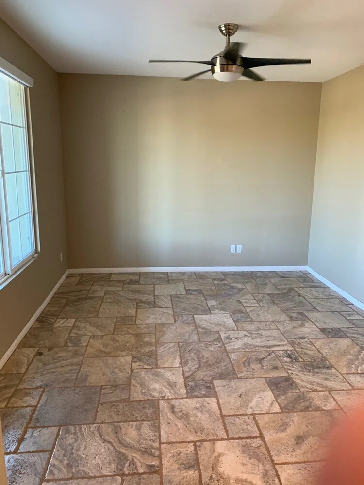 Dining Room or Front Sitting Area. Travertine tile throughout main floor in dining room, kitchen, and hallway. - 84126 Canzone Dr
