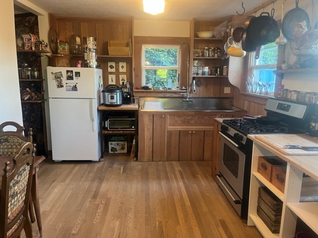 Kitchen half of the front room, refinished oak floors and custom cabinets. - 8950 NE Emerson St
