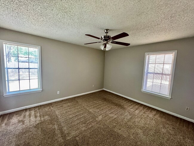 Building Photo - Charming 3BR/2BA Near Southwind | Soaring Vaulted Ceilings, Brick Fireplace & Fenced Yard