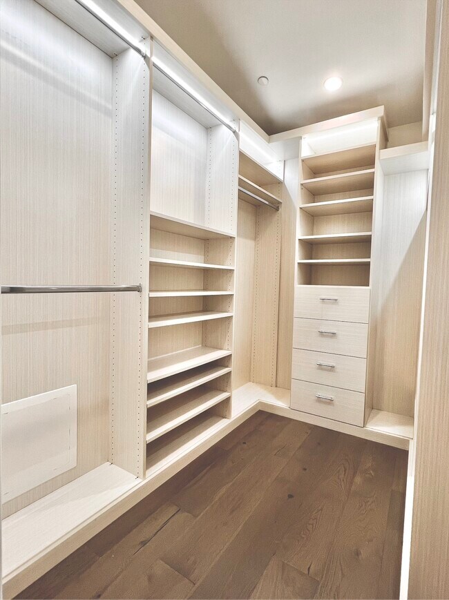 Primary bedroom features a large custom walk-in closet - 6077 Hargis St
