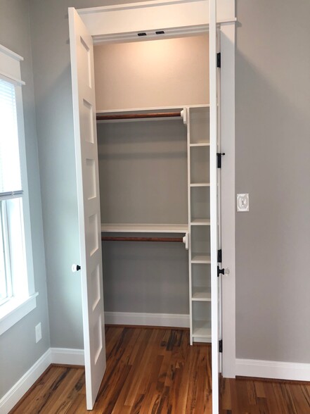 View of bedroom closet with shelving and lighting inside - 1004 Adele St