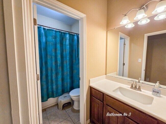 Bathroom # 3 features a full bath with a shower and commode, easily accessible to bedroom # 3 & 4 - 301 Silver Trl