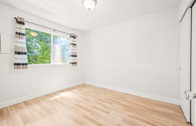 Building Photo - Spacious 2-Bedroom Condo with Forest Views, Private Balcony, In-Unit Laundry & Community Amenitie...