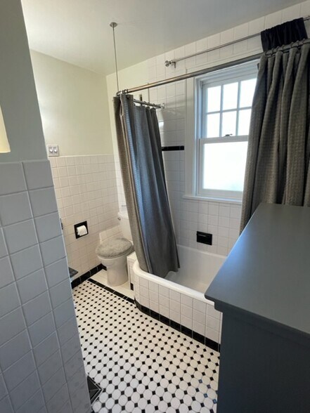 Bathroom. Includes a lovely wood & glass, grey storage cabinet (cabinet top visible in foreground). - 2650 S Shore Dr