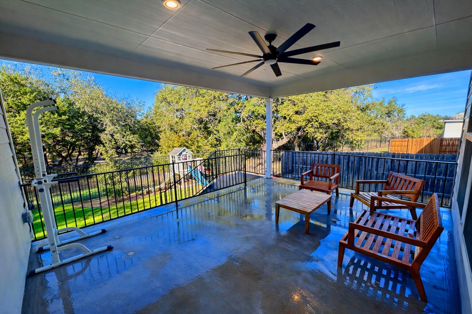 Extended covered back patio with gas hookup for grilling, overlooking a peaceful greenbelt. - 517 Moonlit Stream Pass