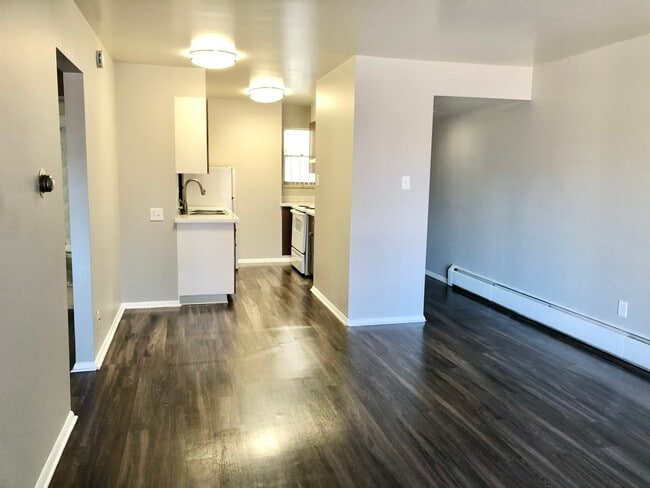 Immerse yourself in this sleek apartment featuring a modern kitchen and open living space. - GRACE LANDINGS APARTMENTS