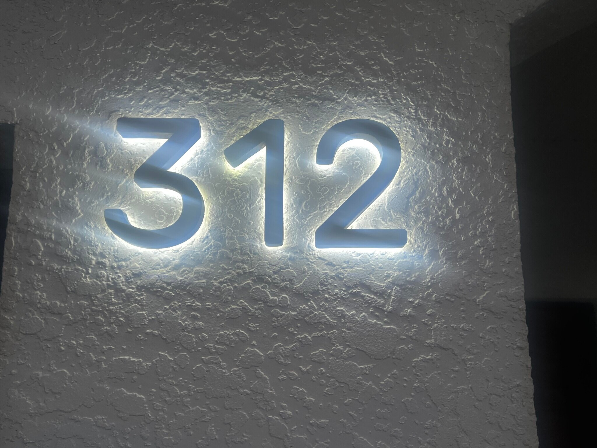 Illuminated house numbers at night - 312 Poinsetta Dr