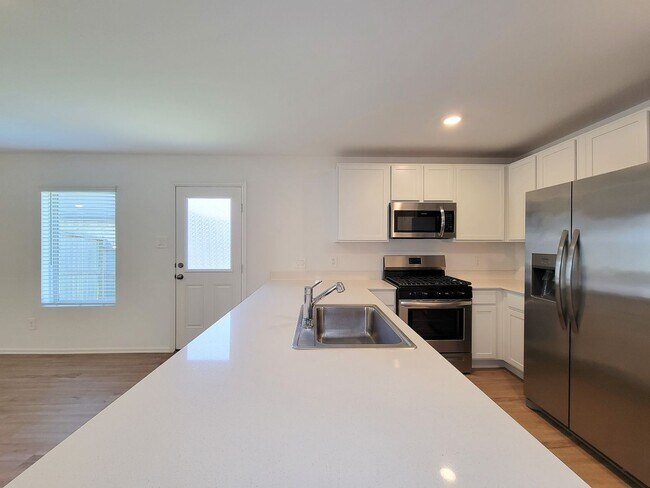 Building Photo - This single-story home has a comfortable layout with three bedrooms and a living area all on one ...