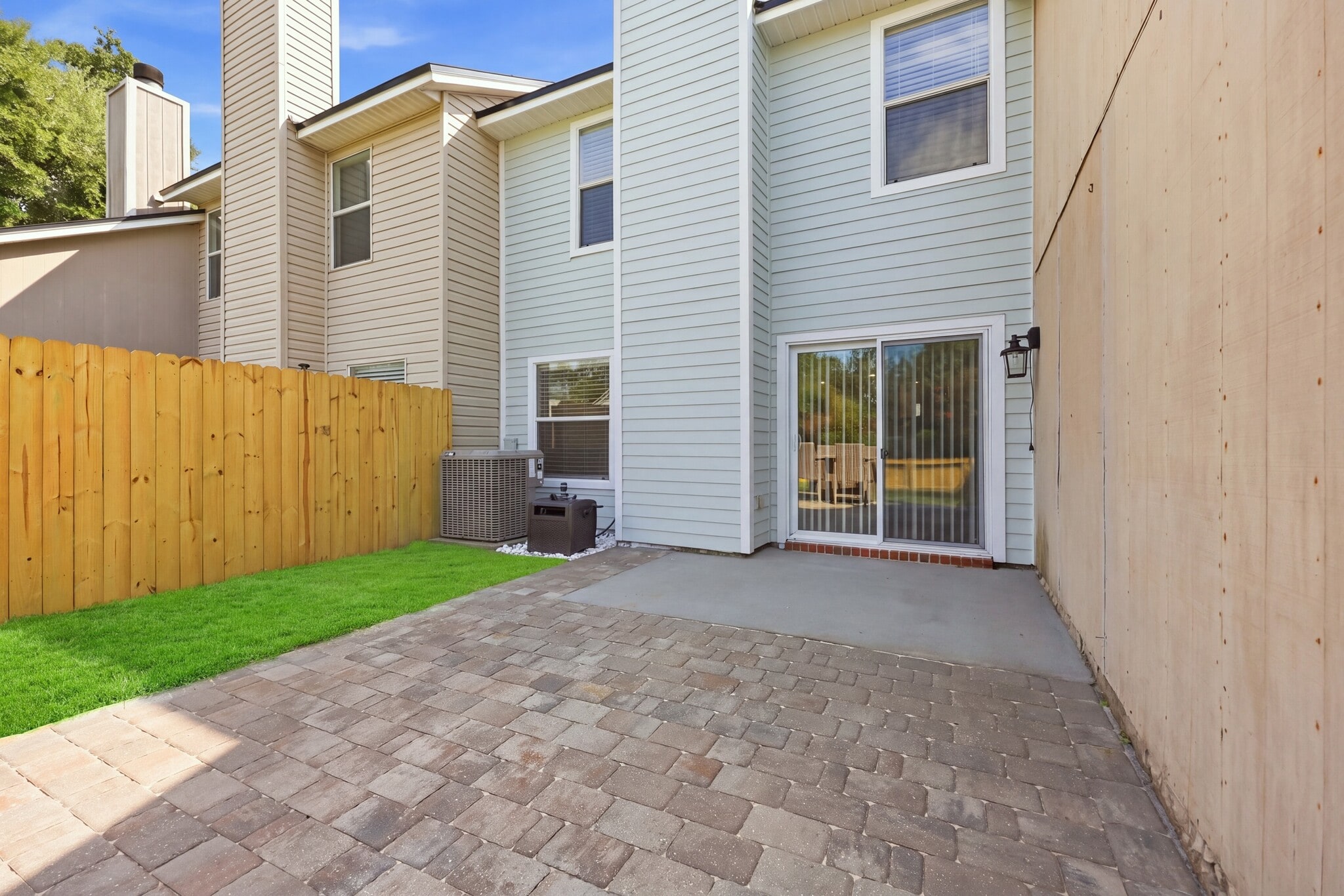 Paver patio extends the living space outdoors with easy access from inside. - 3622 Caroline Vale Blvd