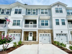 Building Photo - Practically New & Available NOW! Americana Luxury Townhomes! Pet Friendly! Attached Garage! All A...