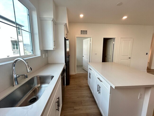 Building Photo - Gorgeous, 3 level townhome, featuring 2 car garage central Air, and in Unit laundry.