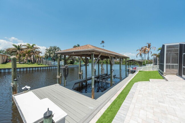 Building Photo - Live the ultimate Space Coast waterfront lifestyle at this stunning beachside canal home in Satel...