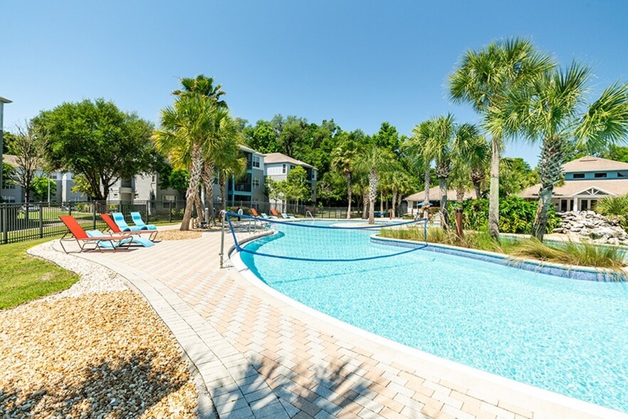 Cabana-Beach-Gainesville-Off-Campus-Apartments-Near-University-of-Florida-Resort-Style-Waterfall-Pool-with-Volleyball - Cabana Beach Gainesville