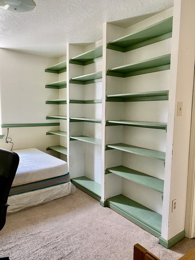 smaller bedroom with bookshelves - 5436 Wilkins Ave